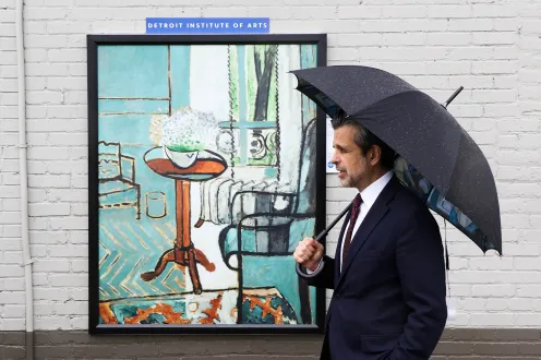 Salvador Salort Pons poses with an umbrella in front of an Inside Out artwork.