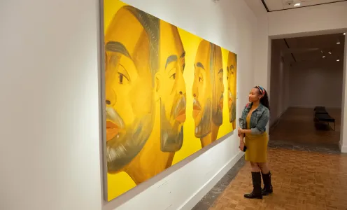 A patron viewing contemporary Black art at the DIA