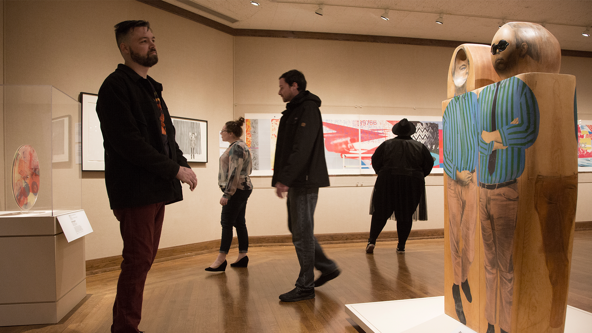 Patrons observing different objects in a Pop Art exhibition