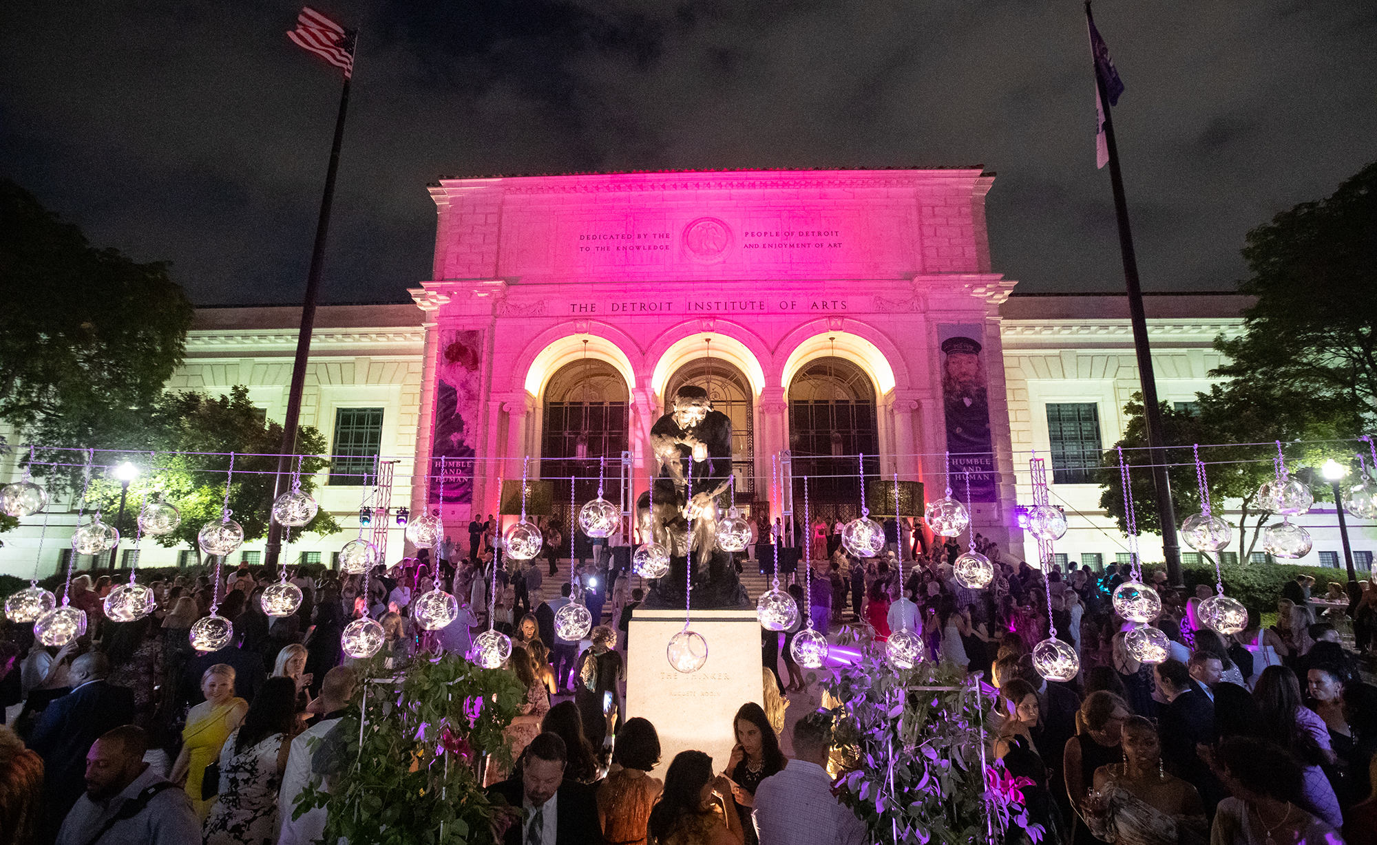 The front of the Detroit Institute of Arts lit up with pink lights for Fash Bash 2019