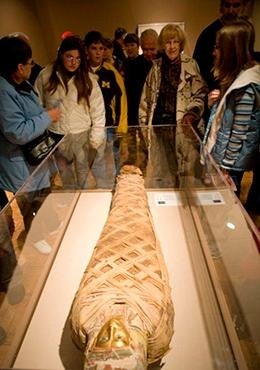 Students viewing Egyptian mummy