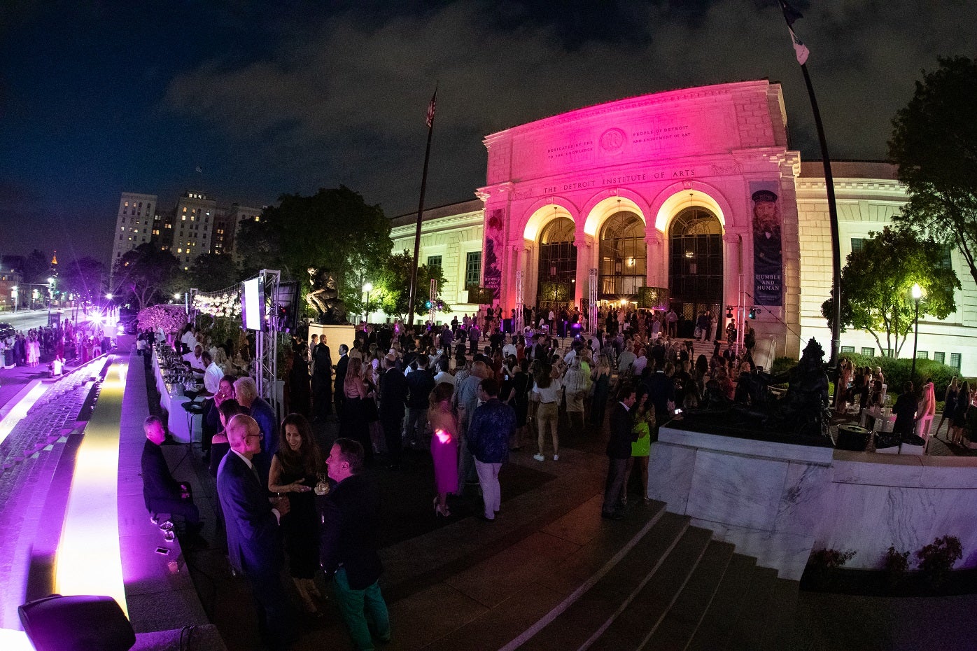 Front facade of the Detroit Institute of Arts light up with purple lights at night during the annual Fash Bash fundraising event.