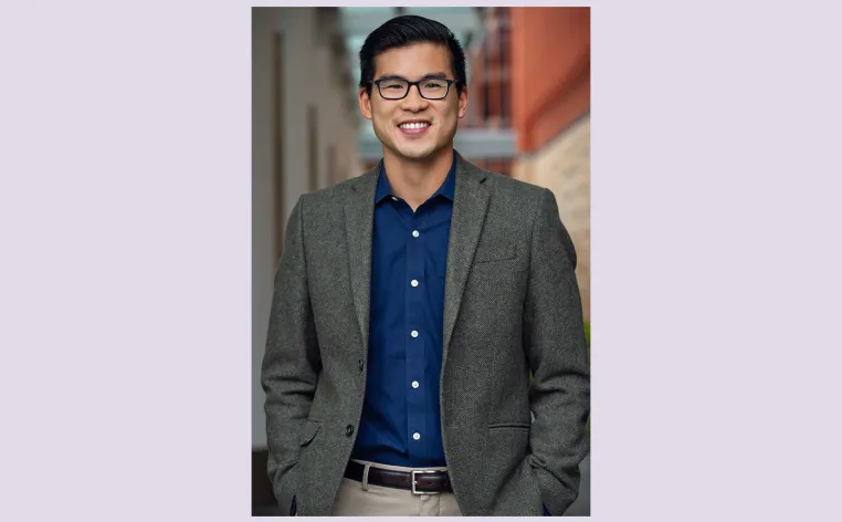 Ian Shin pictured in a gray blazer and dark blue button down shirt with glasses.