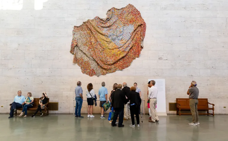 Patrons standing in groups in the Great Hall