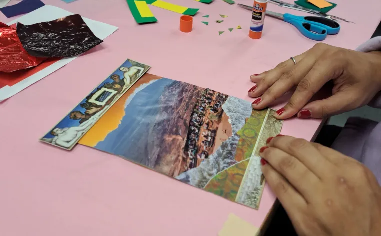 Someone making a mixed-media collage in the DIA's Artmaking Studio