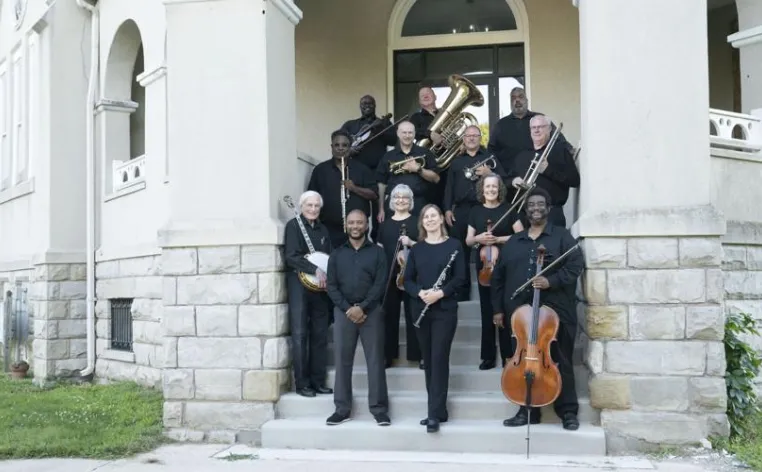 A group of musicians on stone steps