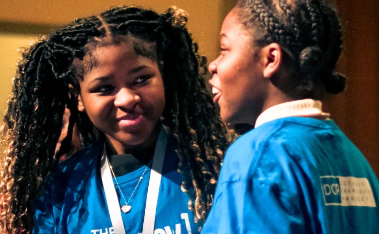 Students on stage at an improv project performance