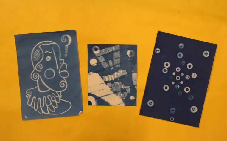 Three Sun Prints,  each eith different white imagery on a blue background