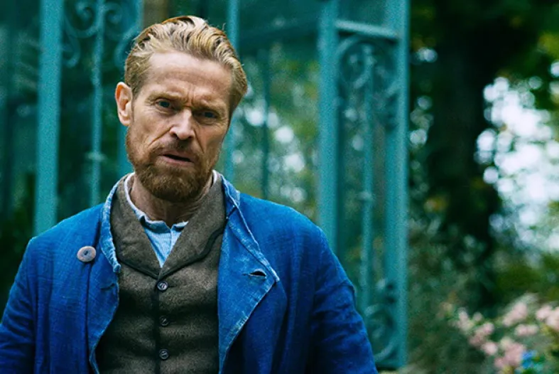 Willem Defoe portraying Van Gogh, standing in a garden
