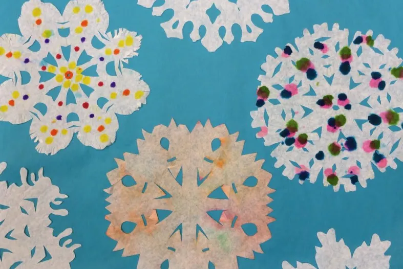Examples of paper snowflakes made in the DIA's art-making studio
