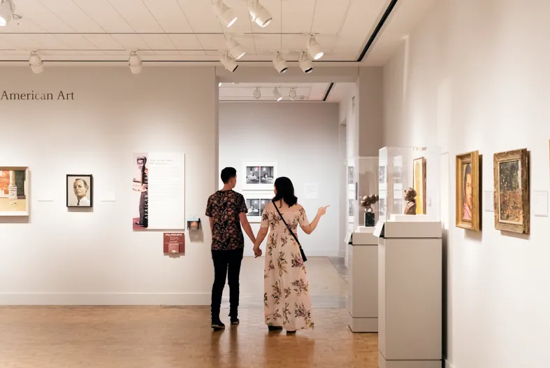 A couple strolling hand-in-hand in the DIA&#039;s African American Art galleries