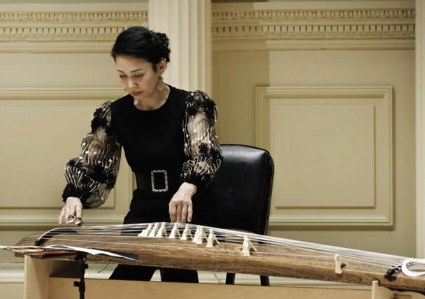 Masayo Ishigure playing a stringed instrument