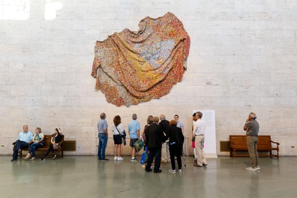 Patrons standing in groups in the Great Hall
