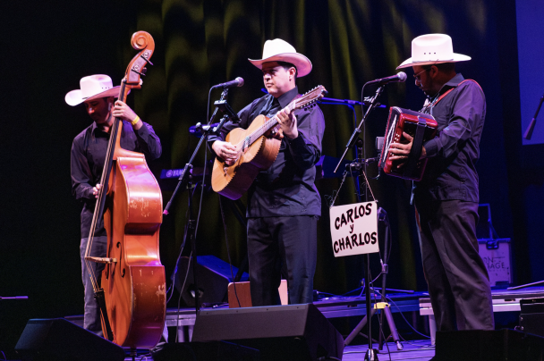 Three people performing on stage