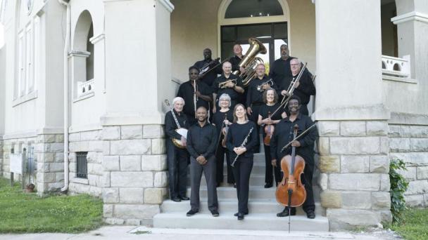 A group of musicians on stone steps
