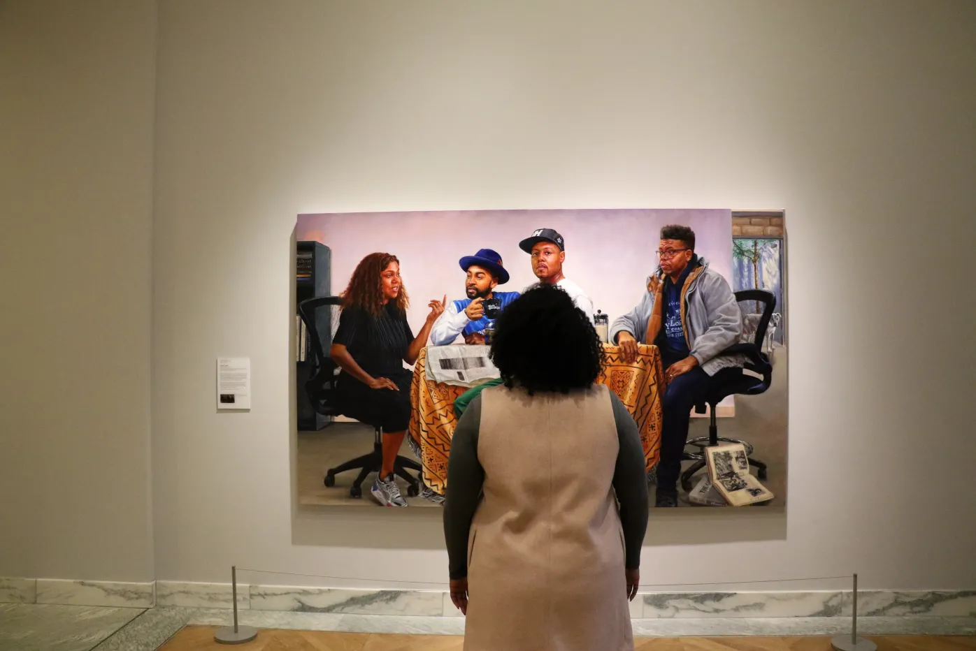 A visitor observes Mario Moore&#039;s &quot;The Council,&quot; in the Detroit Institute of Arts&#039; galleries.