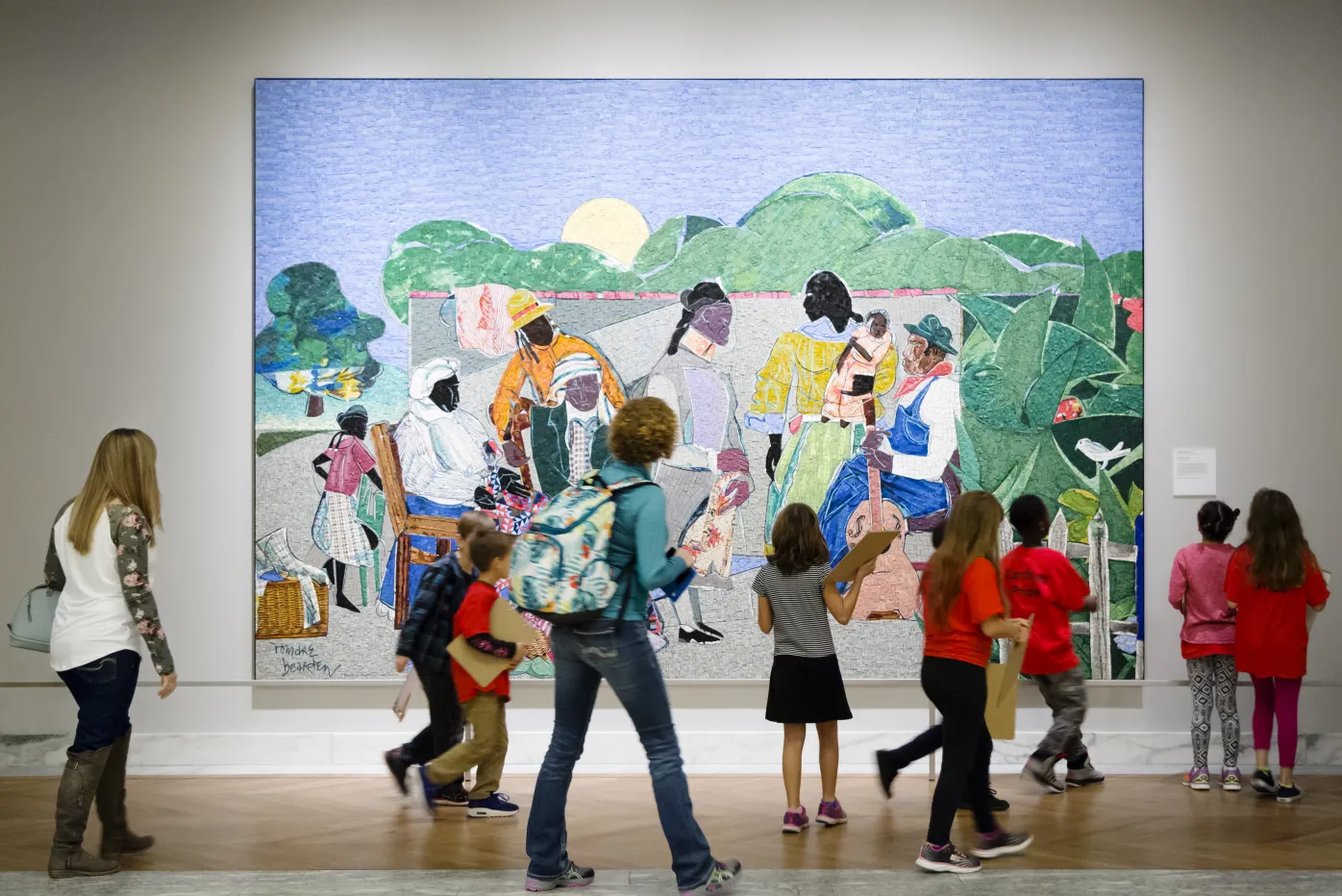 Students and patrons looking at Romare Bearden&#039;s Quilting Time.