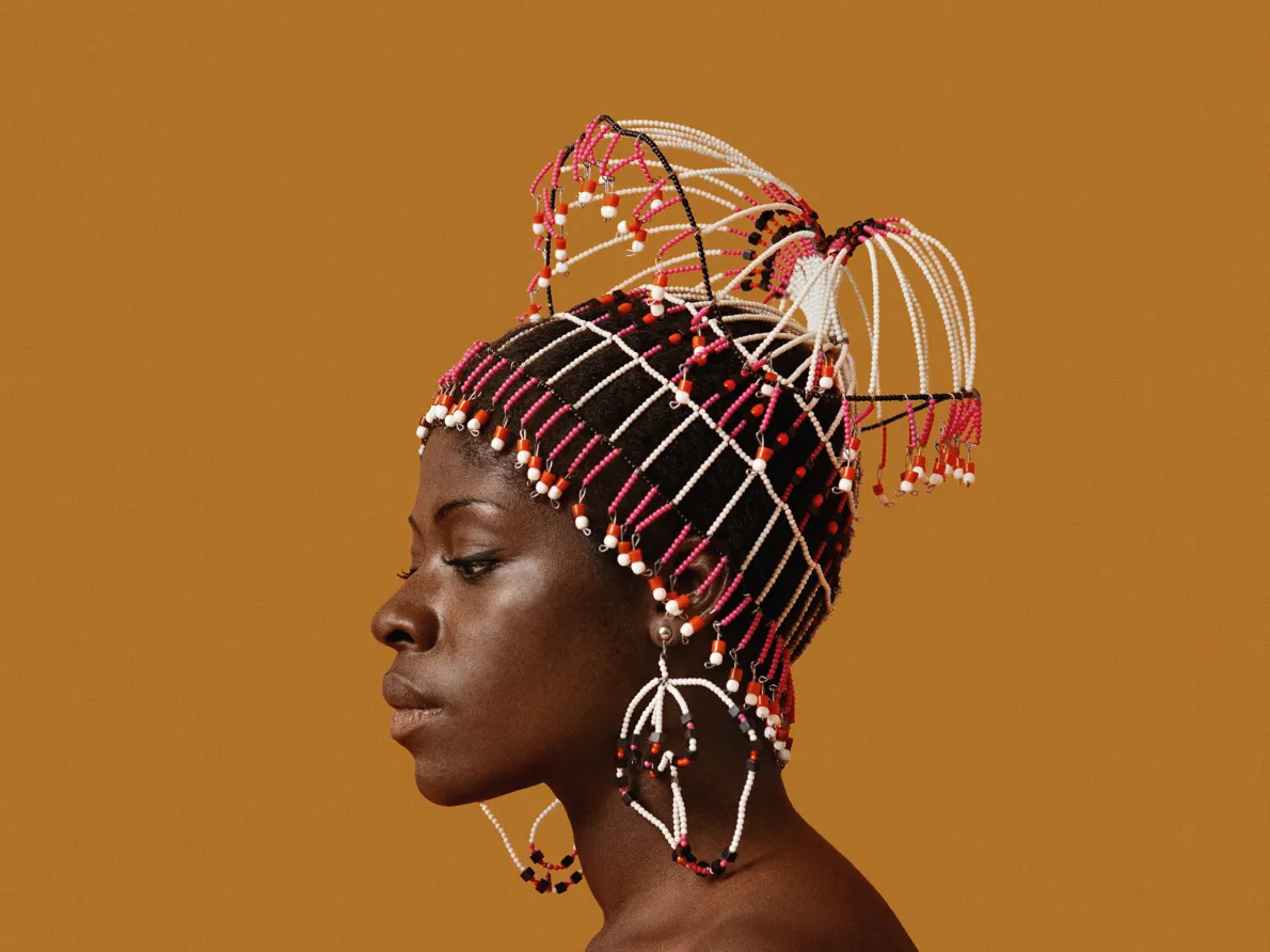 Kwame Brathwaite, Sikolo Brathwaite wearing a headpiece designed by Carolee Prince, African Jazz-Art Society & Studios (AJASS), Harlem, ca. 1968; from Kwame Brathwaite: Black Is Beautiful (Aperture, 2019)
