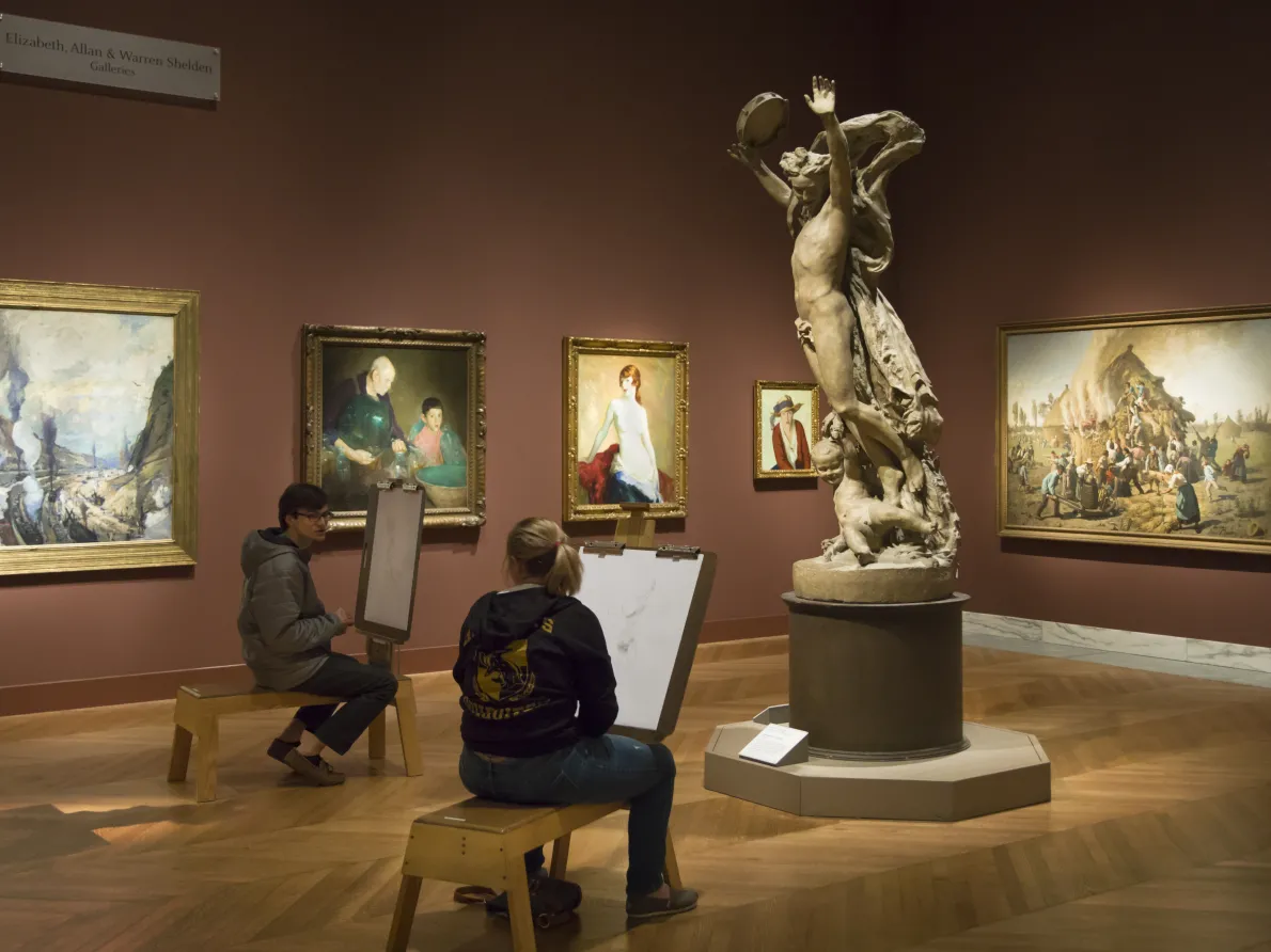 People drawing inside of a gallery in the Detroit Institute of Arts