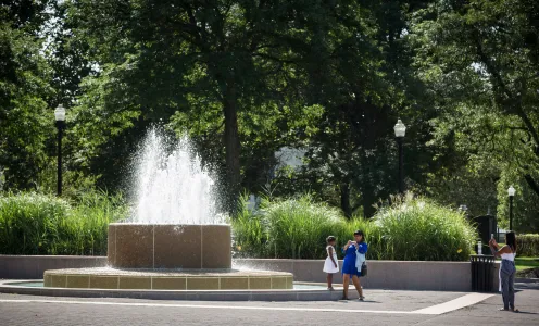 A young girl poses for the camera in front of one of the DIA fountains