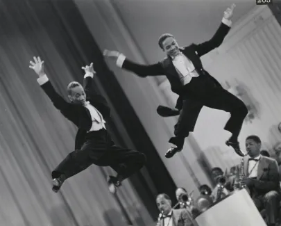 The Nicholas Brothers in a scene from Stormy Weather (1943), from left, Fayard Nicholas and Harold Nicholas. Photographic print, gelatin silver. Courtesy Margaret Herrick Library, ©Twentieth Century
