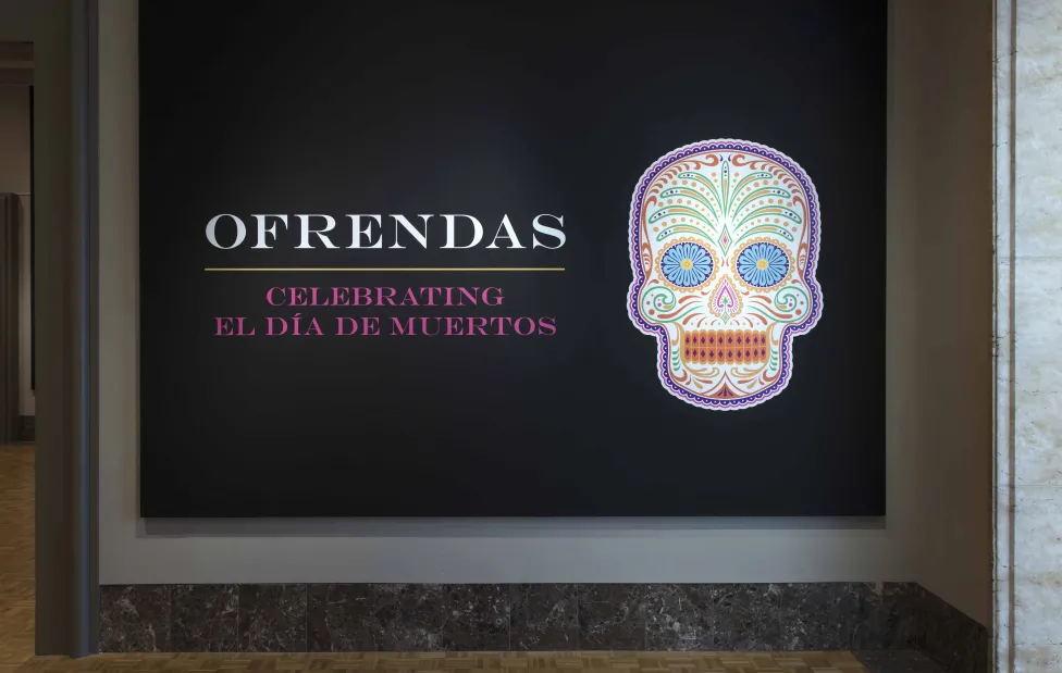 The main entrance for the Ofrendas exhibition, featuring the sugar skull logo
