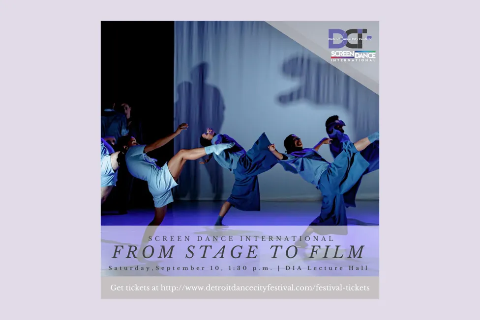 Dancers in blue lean back in unison on stage