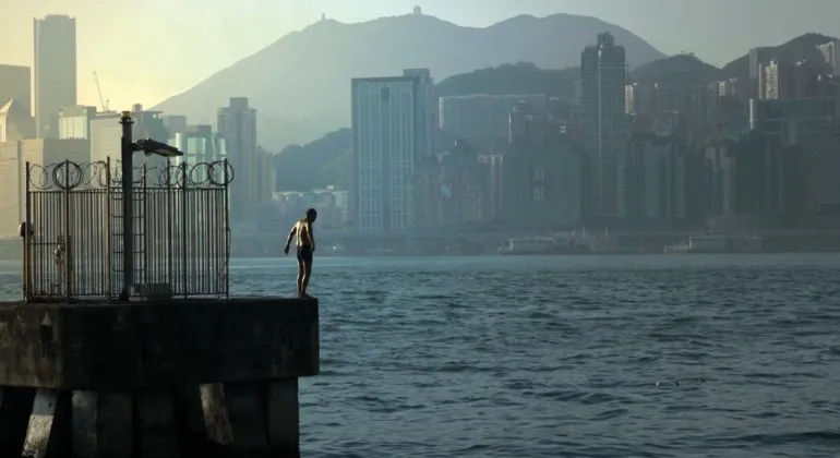 Plan in swimsuit on the edge of dock