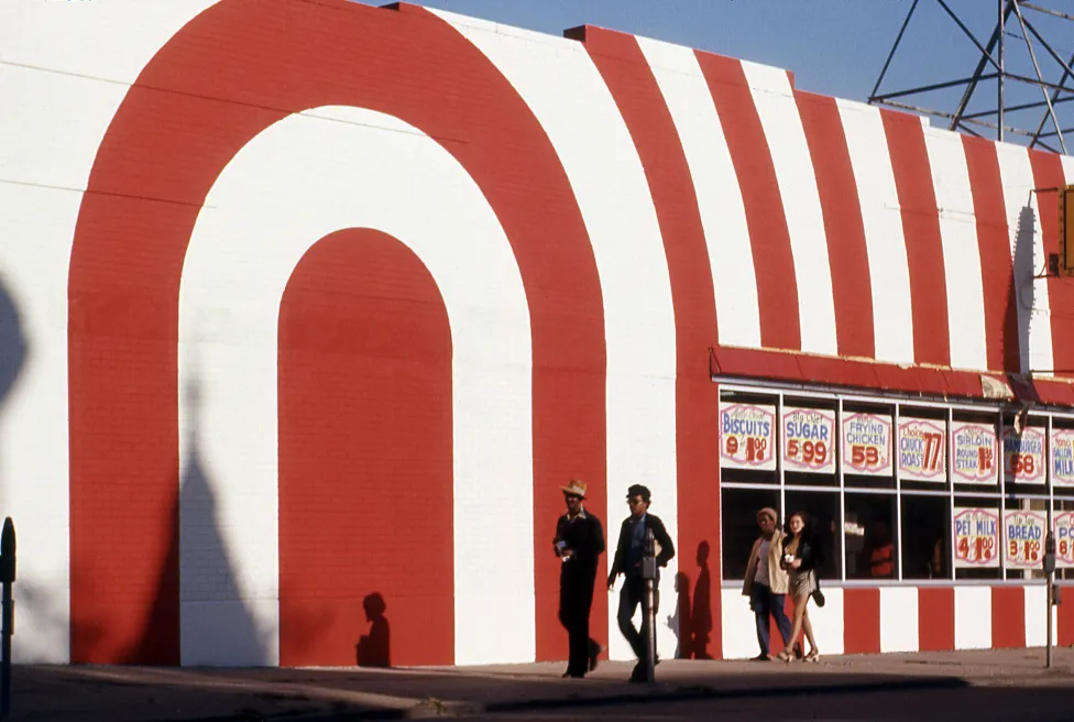 “Untitled (Red and White Striped Storefront with Passersby),” around 1970, attributed to Allen Stross, color transparency film. Detroit Institute of Arts