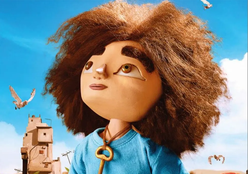 A clay figure of a child with big, brown, curly hair and a key around their neck.