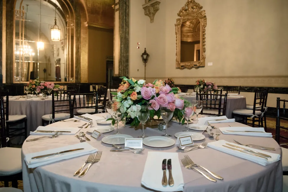 Dressed and set round tables with floral arrangements in Crystal Gallery