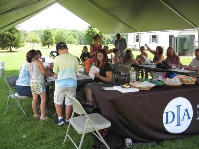 Families making art in the DIA's off-site art-making tent