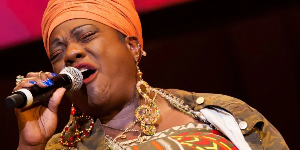 Thornetta Davis singing at a microphone.