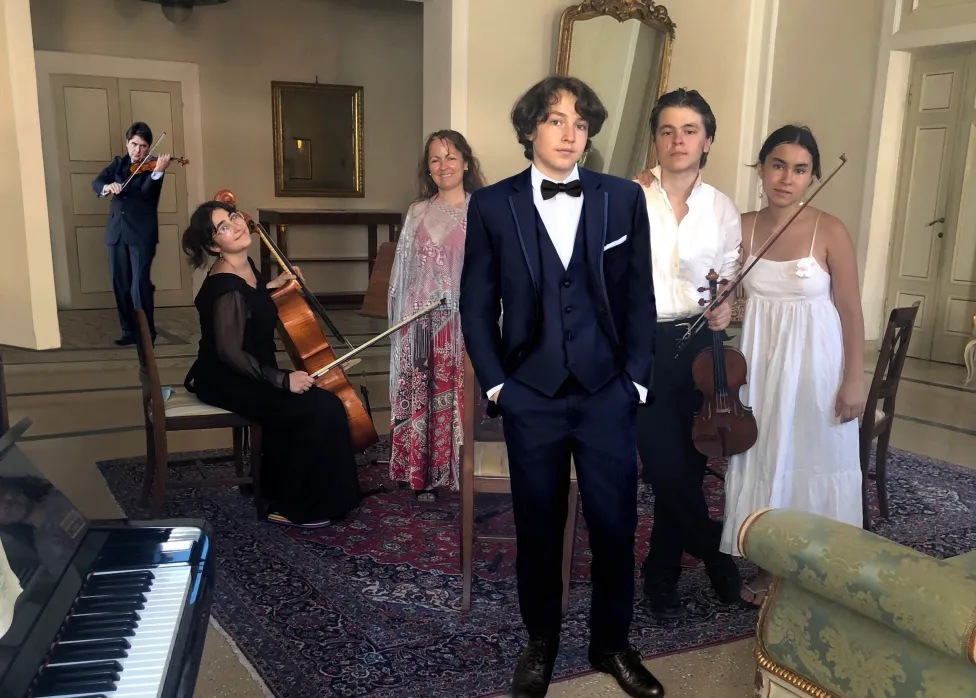 Eric Grossman and family pose in formal wear with their instruments.