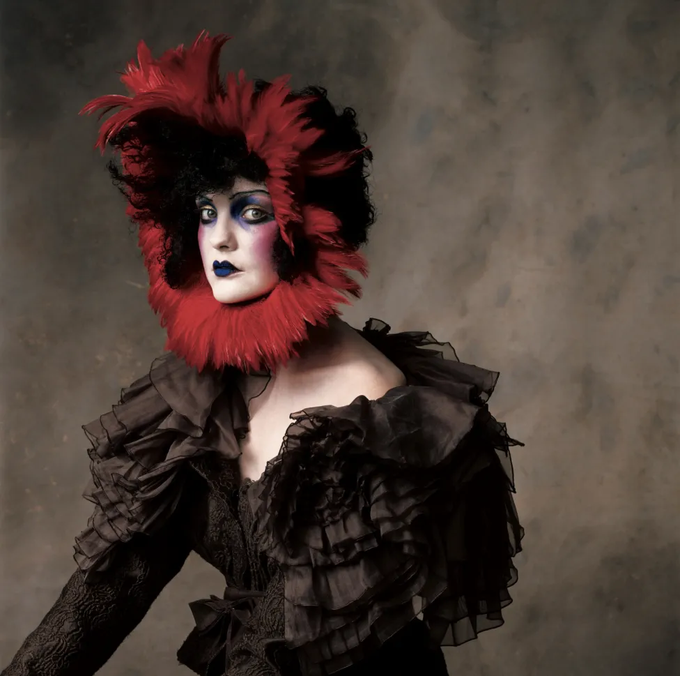 Irving Penn, “John Galliano Silk Wool Jacquard Jacket with Red Feather Headpiece,” New York, 2007, ©Condé Nast