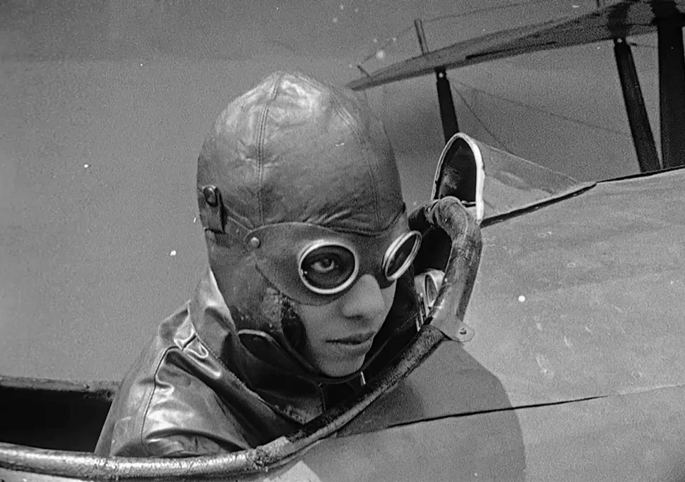 A pilot in an old leather cap and goggles.