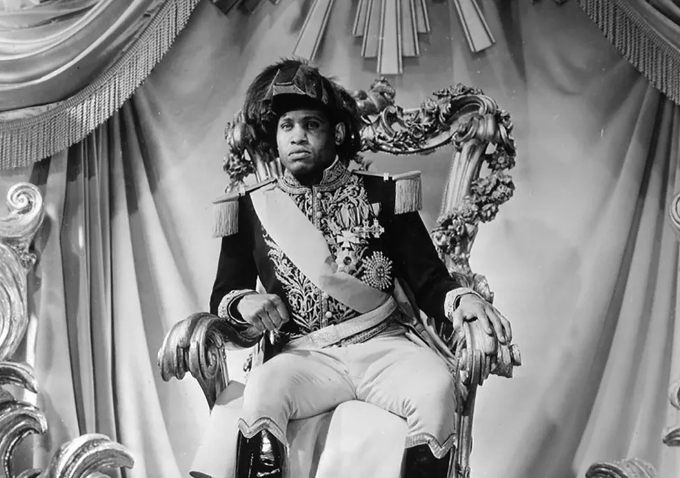 A man in a French captain's uniform sits on a throne.