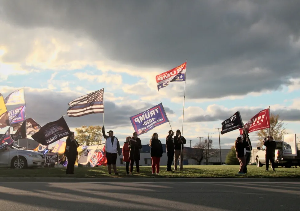 Conservative protestors line up alongside a road