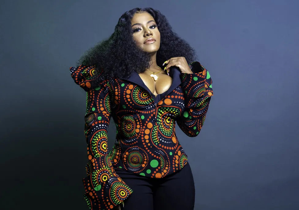 Etana posed in a colorful shirt