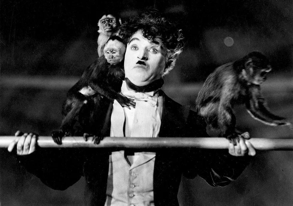Man with mustache and a monkey on his shoulder