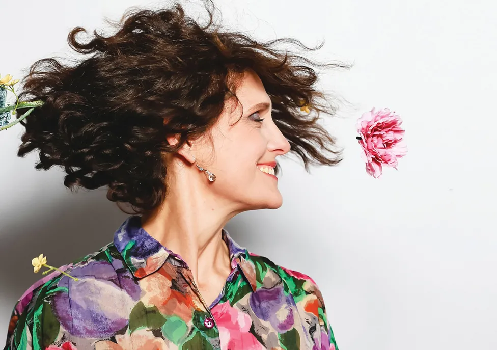 Woman in colorful shirt in the middle of a twirl.