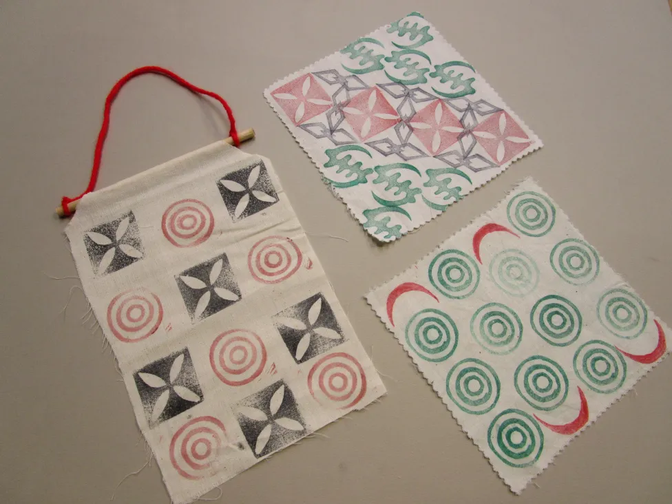 Examples of adinkra cloth made in the Detroit Institute of Arts' Artmaking Studio