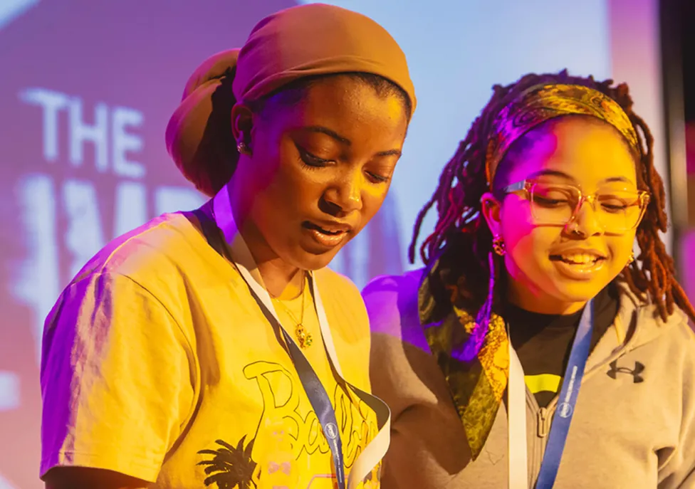Two students on stage in yellow