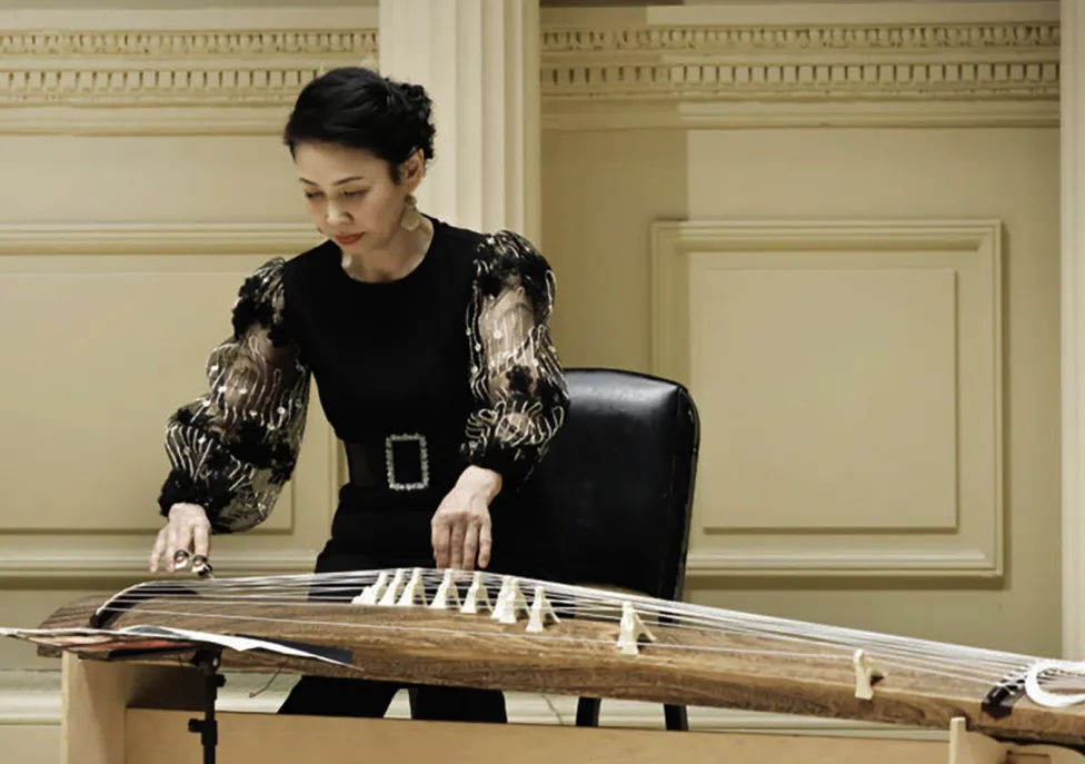 Masayo Ishigure playing a stringed instrument