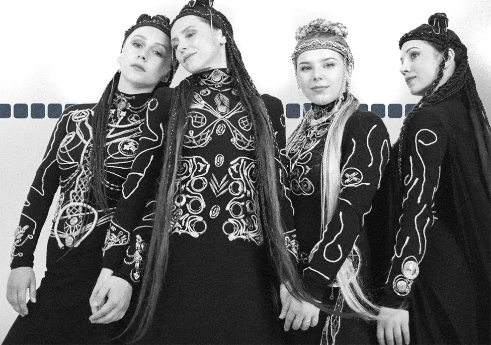 Four women with long, braided hair
