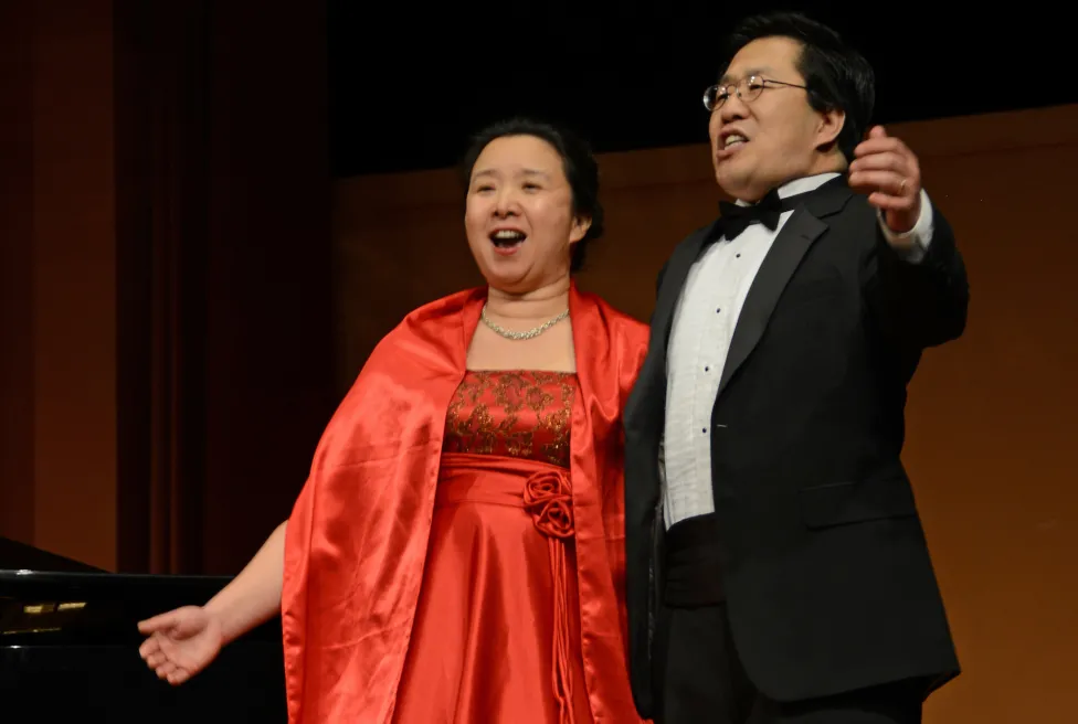 Two people singing on stage