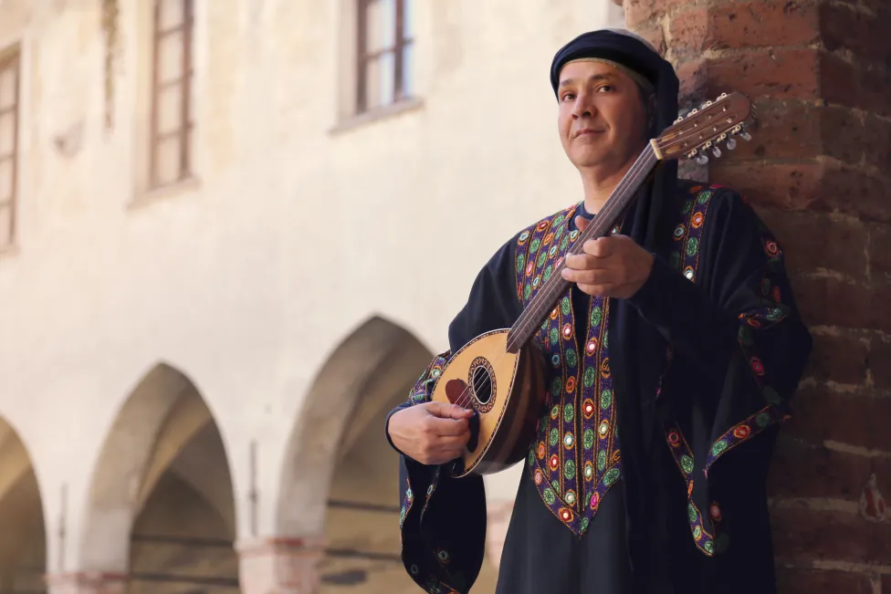 A person playing a lute-like instrument