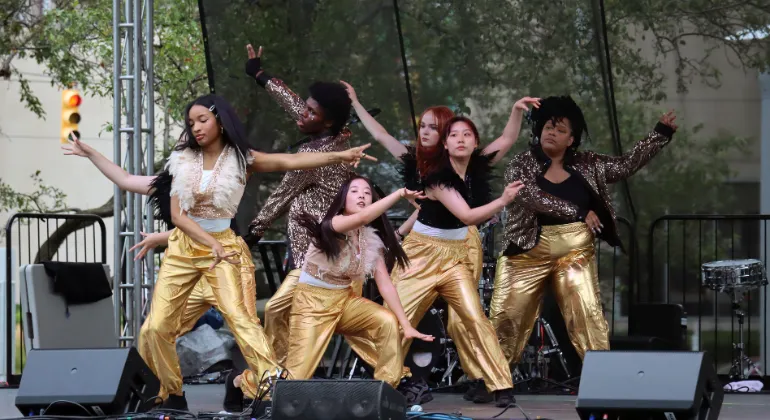 Artlab J's K-pop dance team dancing in matching gold pants