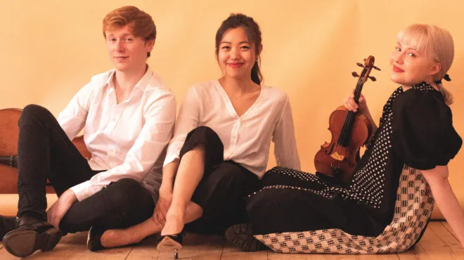 Three seated musicians