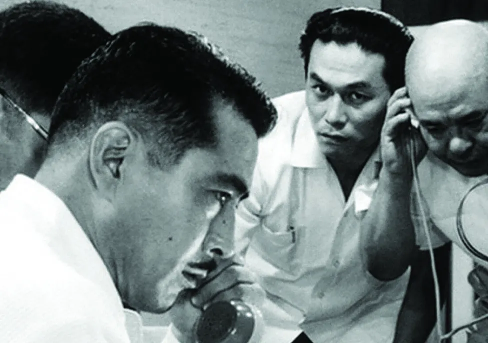 Four men listening to two phones